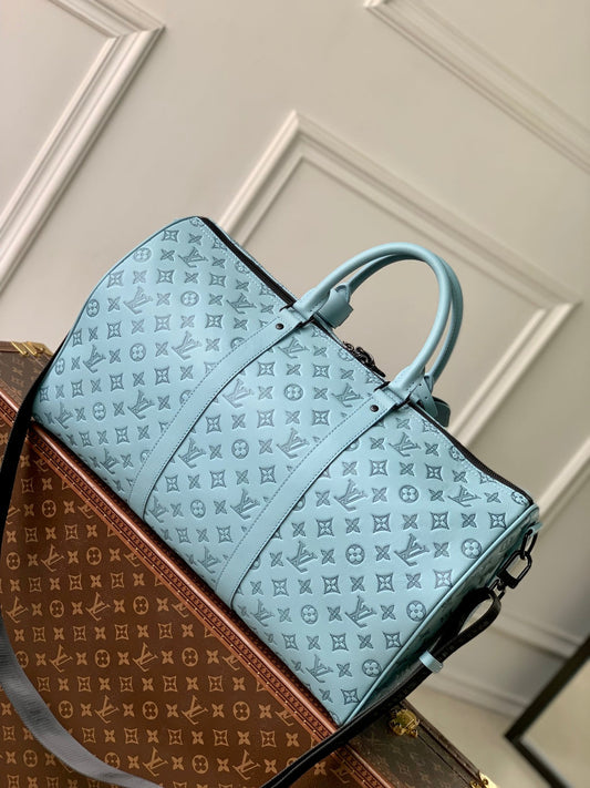 KEEPALL BANDOULIÈRE 50 IN SKY BLUE MONOGRAM SHADOW EMBOSSED CALFSKIN
