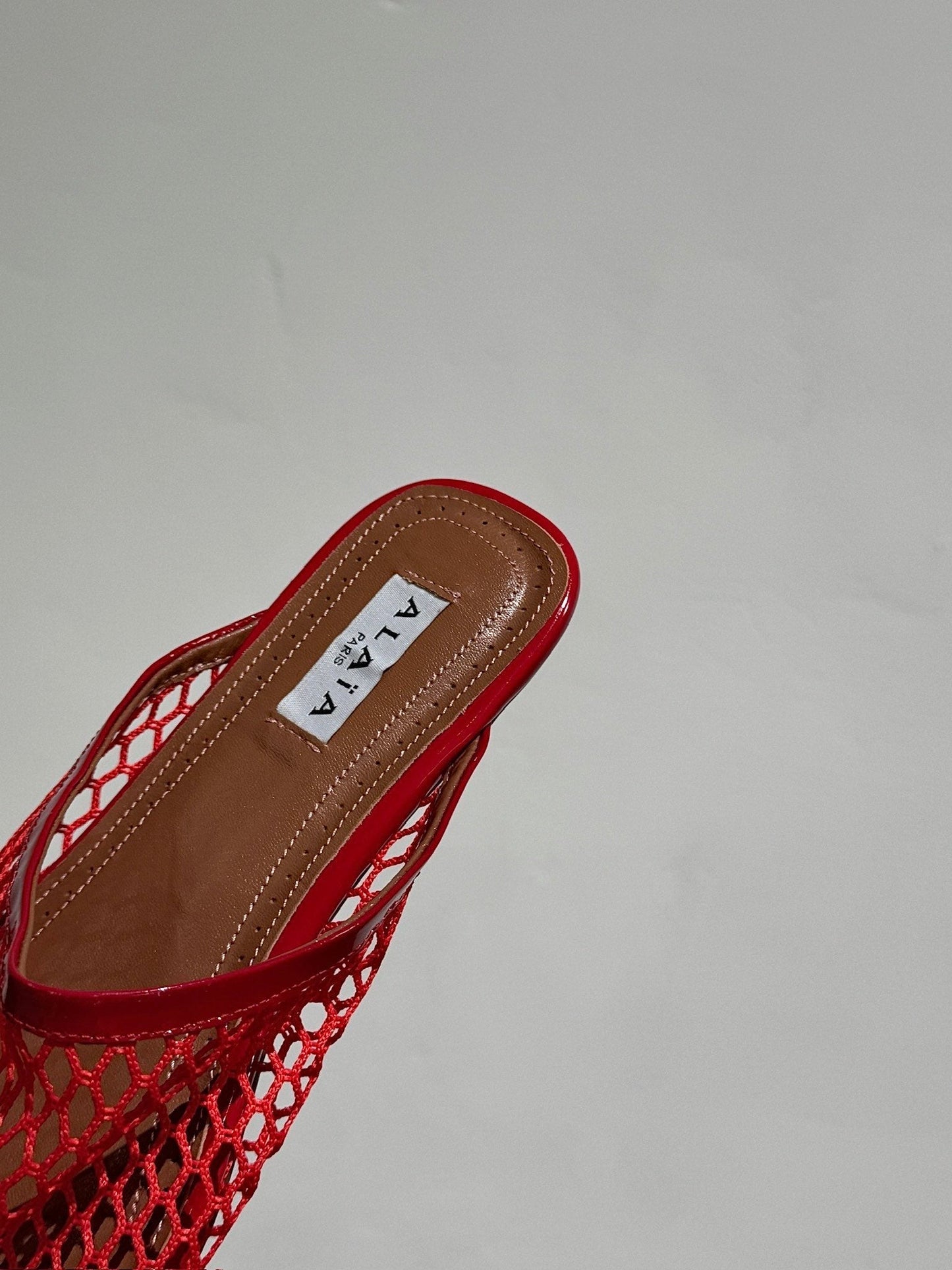 ALAIA FLAT MULES IN CHERRY RED MESH FISHNET - 34