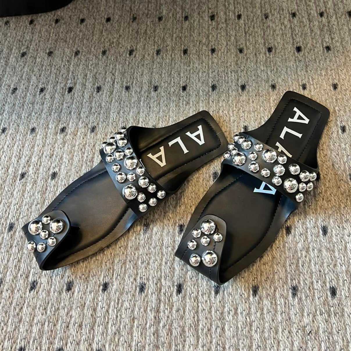 ALAIA FOLDED FLAT MULES WITH SPHERES ON BLACK CALFSKIN - 35