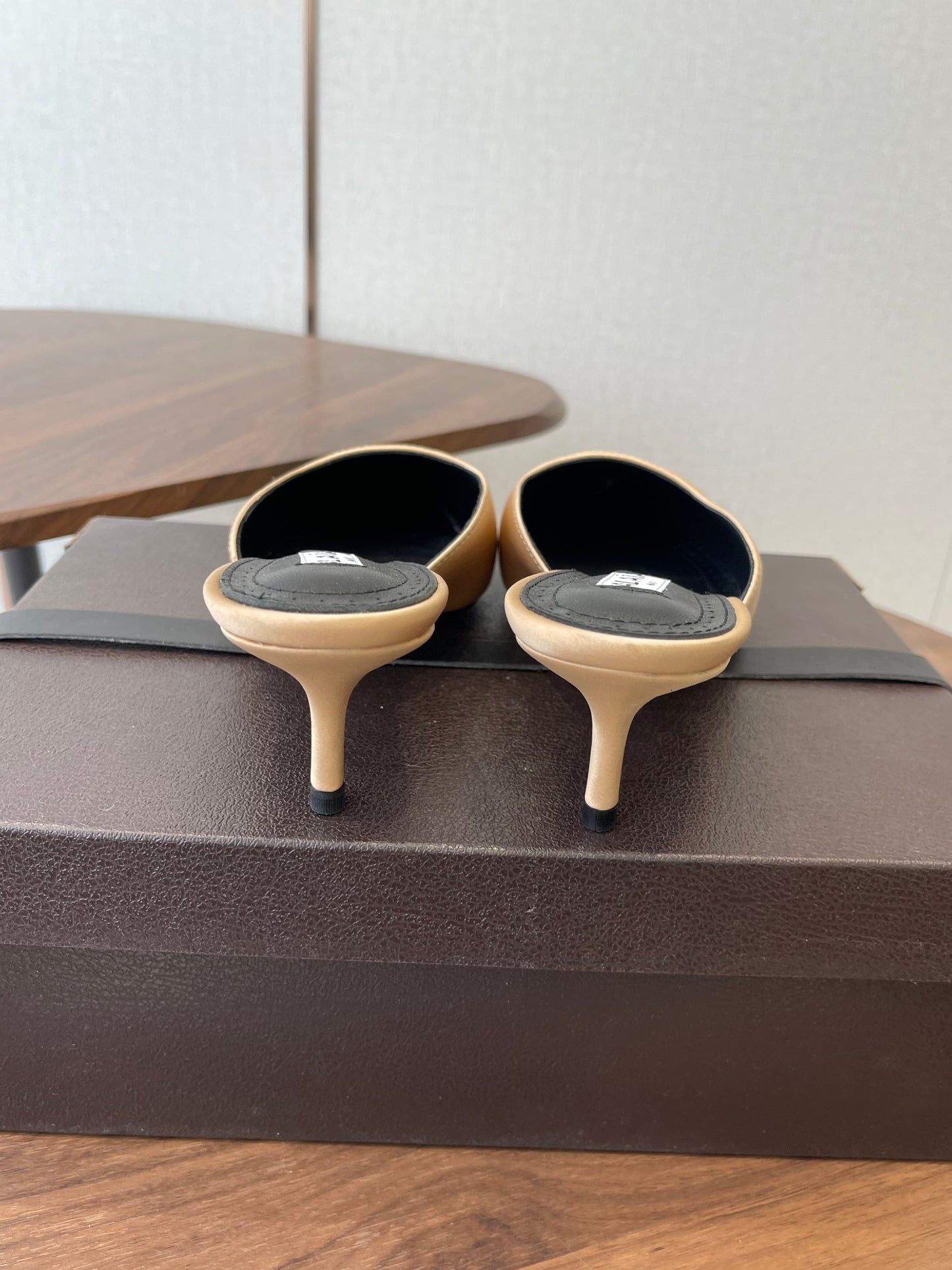 ALAIA 26S HEELED MULES 50 MM IN WARM BEIGE FABRIC