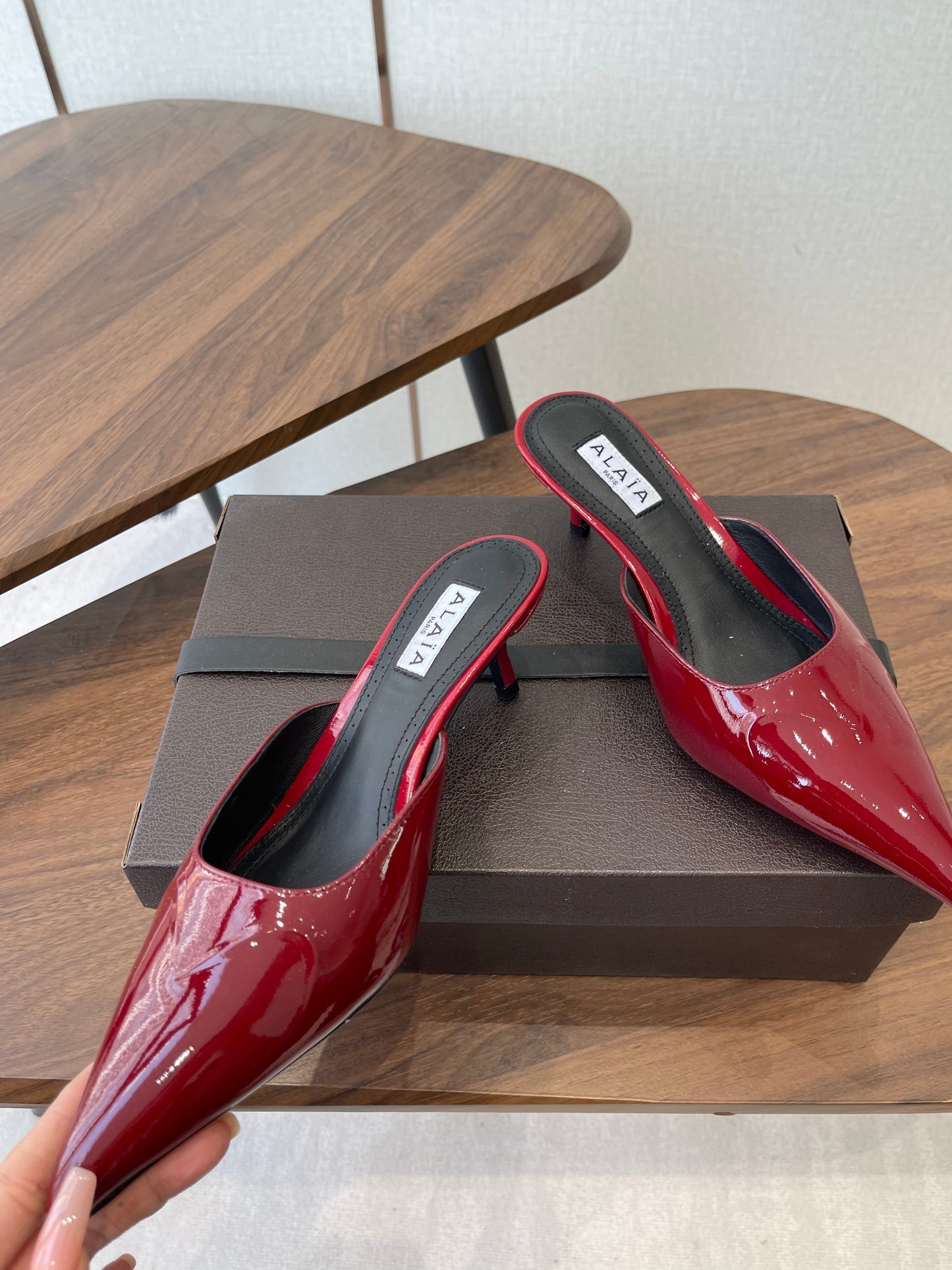 ALAIA 26S HEELED MULES 50 MM IN DARK RED GLOSSY CALFSKIN