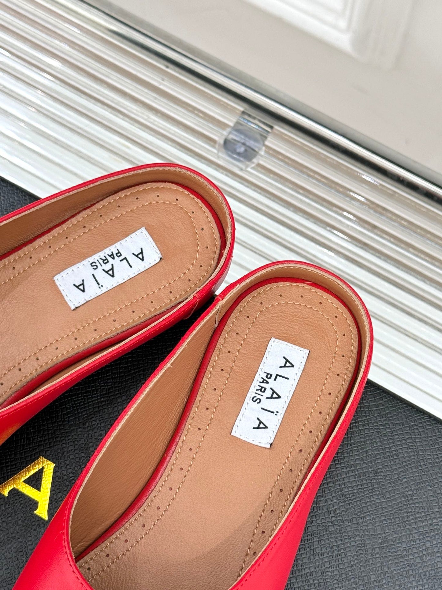 ALAIA FLAT MULE IN CRIMSON RED LAMBSKIN WITH GOLD HARDWARE - 35