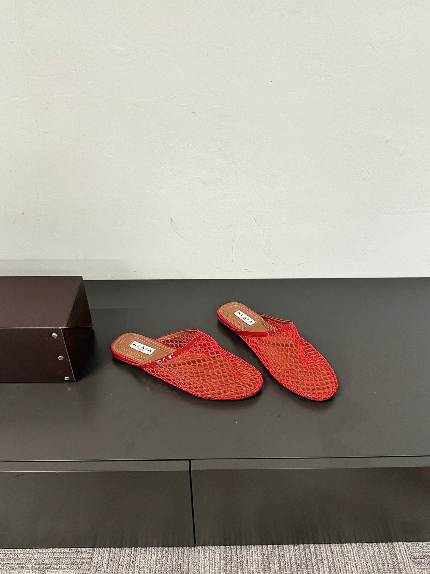 ALAIA FLAT MULES IN CHERRY RED MESH FISHNET - 34