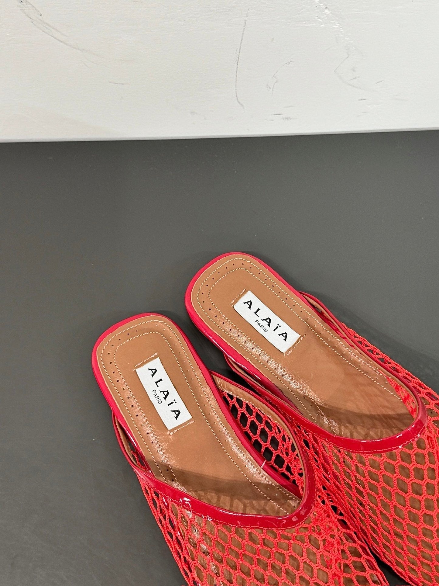 ALAIA FLAT MULES IN CHERRY RED MESH FISHNET - 34