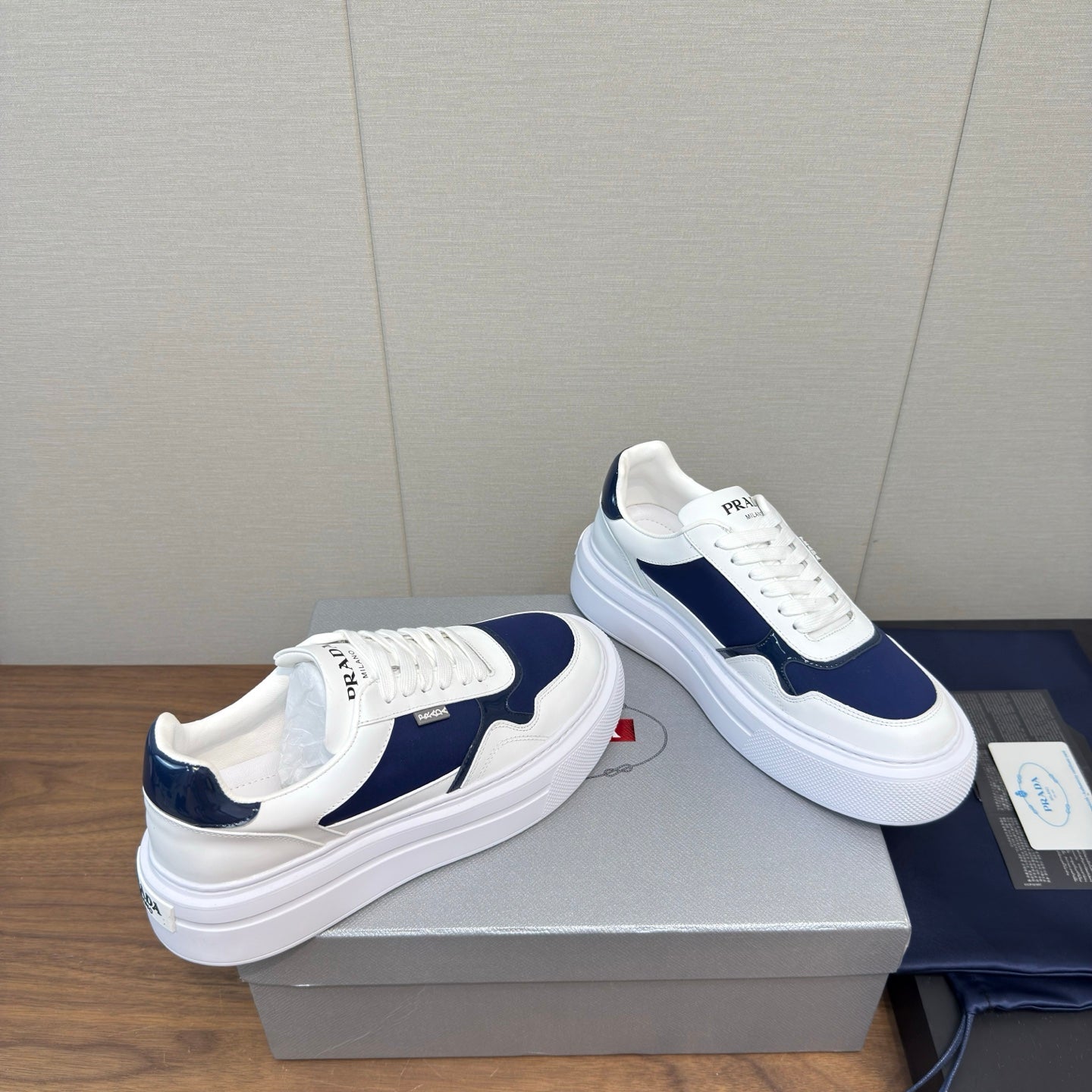 PRADA 25S DOWNTOWN BOLD SNEAKERS 45MM IN WHITE AND NAVY BLUE CALFSKIN - 35