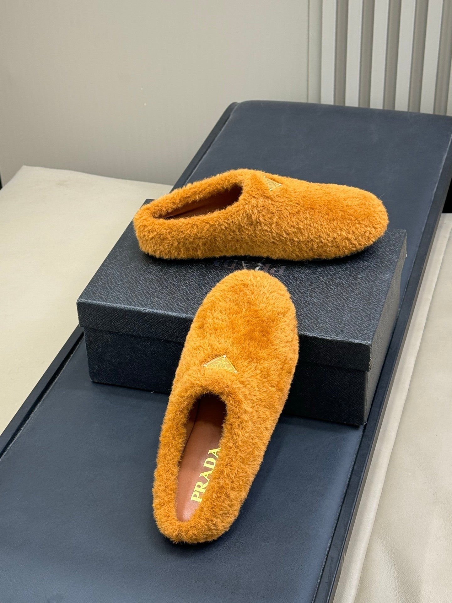 PRADA 25S CLOGS IN DARK ORANGE SHEARLING - 35