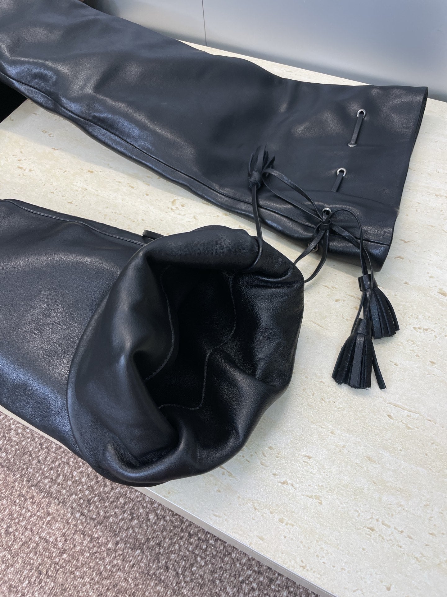 YSL 25S HIGH‑HEEL FRINGED MARTIN BOOTS 90 MM IN BLACK LAMBSKIN - 35